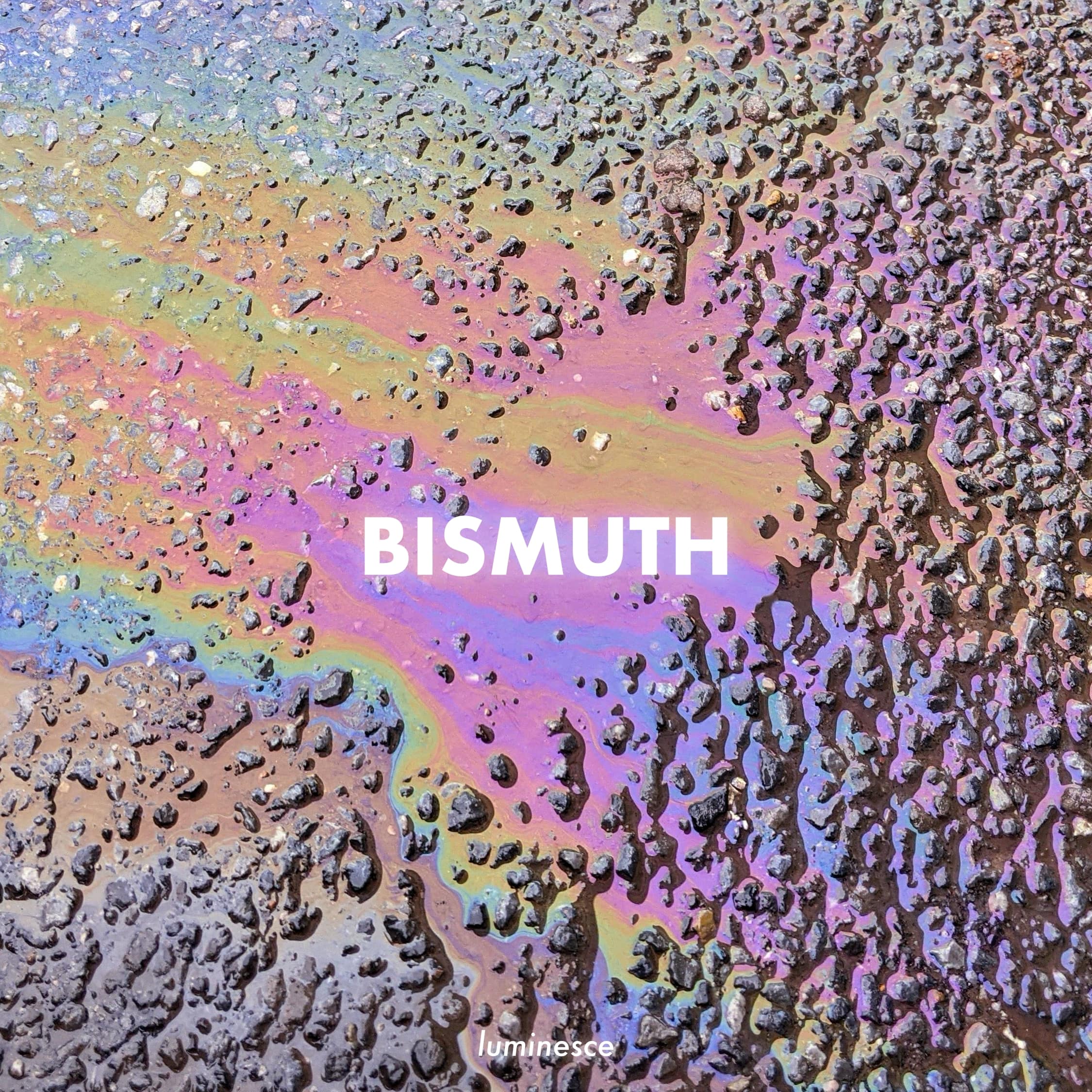 cover art featuring an iridescent pool of oil in a parking lot